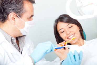 Dentist teaching to brush teeth