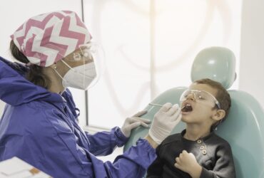 child-with-dentist-dental-office-dental-treatment-children-s-clinic-min-scaled