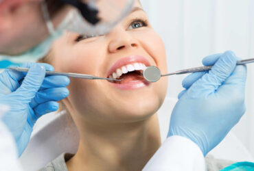 Dental health. Male hygienist examining patient teeth on caries